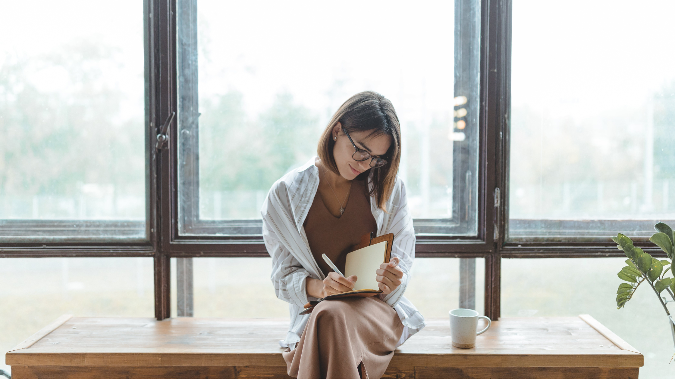 Woman writing in a journal.